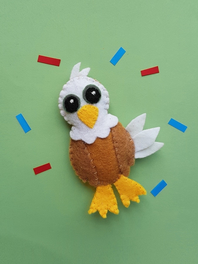 Brown felt bald eagle with a white head and yellow beak