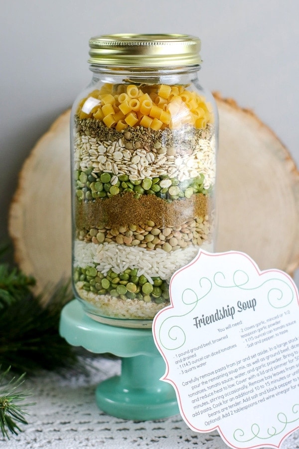Layered friendship soup mix in a jar with a recipe gift tag