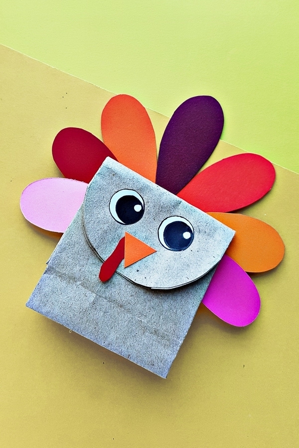 Small paper bag turkey with colorful tail feathers