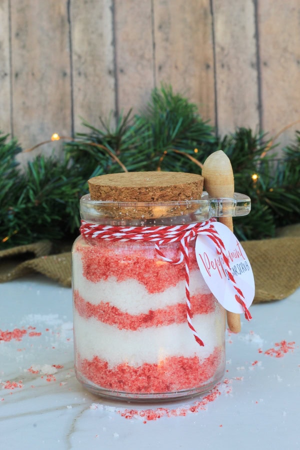 Jar of pink and white peppermint sugar scrub with a round gift label