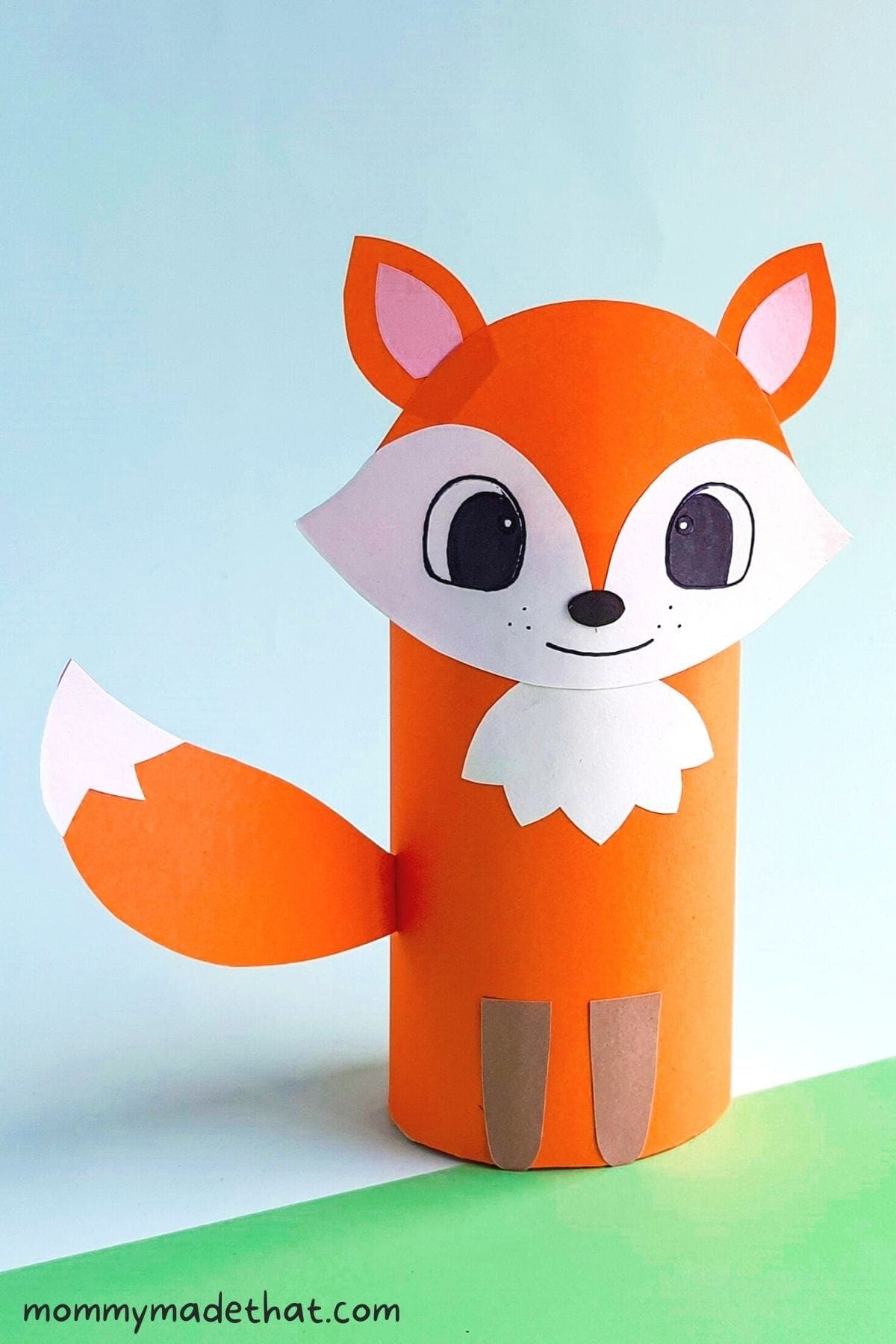 Orange paper roll fox with a white face and bushy tail